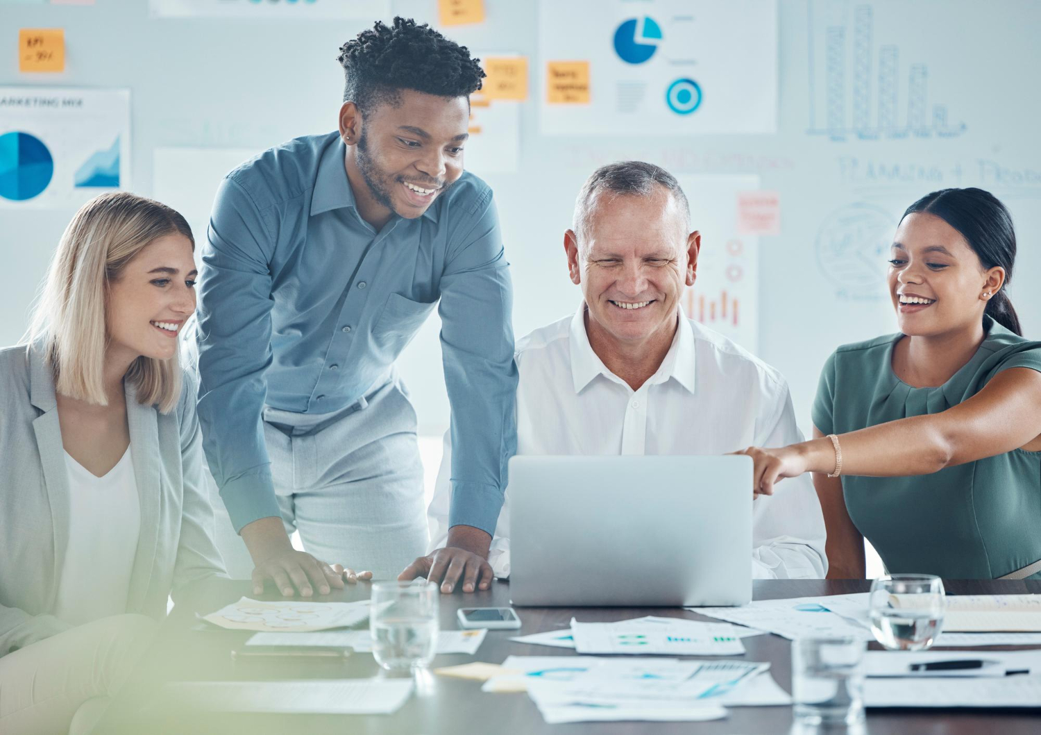 Group of people reviewing information on a laptop